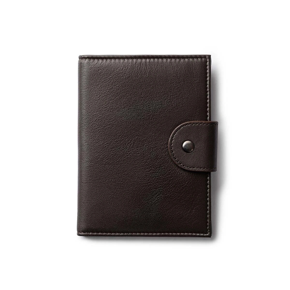 Orbit Smart Passport Holder Bi-Fold in Brown leather with Dolphin Max tracker attached to a passport and travel essentials