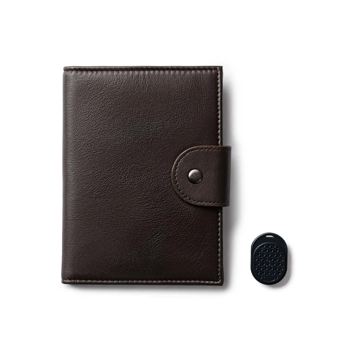 Orbit Smart Passport Holder Bi-Fold in Brown leather with Dolphin Max tracker attached to a passport and travel essentials