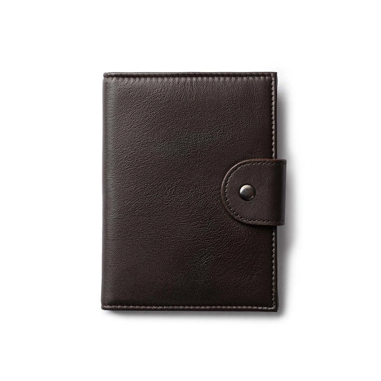 Orbit Smart Passport Holder Bi-Fold in Brown leather with Dolphin Max tracker attached to a passport and travel essentials